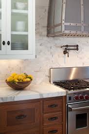 Wood Tone Kitchen Cabinets With Marble Or Quartzite Counter And White Wall Cabinets Wood Tone Kitchen Cabinets Kitchen Remodel Kitchen Marble