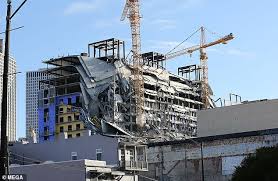 Construction workers look on after a large portion of the hard rock casino hotel under construction in new orleans suddenly collapsed on 12. Victim Of New Orleans Hard Rock Hotel Collapse Is Formally Identified Express Digest