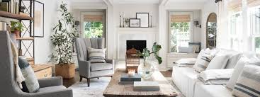 As seen on fixer upper, the swartz's remodeled living room has an open staircase, floor to ceiling windows and hardwood floors. Remodelaholic Get This Look Fixer Upper Mountain House Living Room