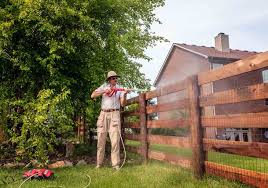 Cleaning a wooden fence before painting