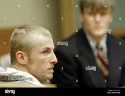 Jeremy Kelley, left, looks at the prosecutor, Friday, June 4, 2004, as  Matthew Carter, right, listens in court in Knoxville, Tenn. The two men,  along with Alford Morgan, are charged with first-degree