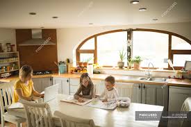 He _ a lot of. Siblings Drawing While Mother Working On Laptop In Kitchen At Home Self Isolation Home Schooling Stock Photo 209278186