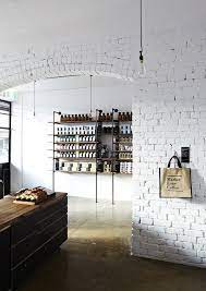 Chemical and gel masonry strippers are the solution for. Exposed Brick Wall Painted White Concrete Floor Aged Wood And Industrial Minimal Shelves And Shop Interiors White Brick Walls Exposed Brick Walls