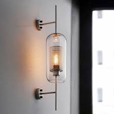 If you are going higher, just be sure to consider the window frame height. Modern Farmhouse Cylindrical Glass 1 Light Antique Brass Wall Sconce For Hallway Living Room Wall Sconces