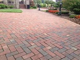 Start by digging out the area where you'd like to place your stone paver patio. This Long Brick Driveway Is Made With Pine Hall Brick Old Towne Pavers Backyard Landscaping Brick Paver Driveway Backyard Retreat