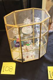 For displaying your favorite items, a curio case is a wonderful way to do it. Lot 108 Tabletop Brass Curio Cabinet W Crystal Figurines Estatesales Org