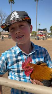 Just when you think your kid won't win a chicken... again….there are  hundreds of kids out there. He walks up with this rooster. I don’t know  what is better, the shocked look