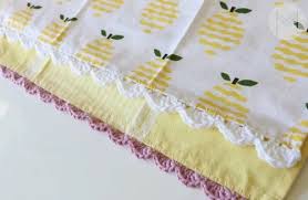 With a size f crochet hook, make the base row by single crocheting across the top of the towel, placing one stitch into each of the holes you punched. How To Crochet A Scallop Edge On A Kitchen Towel Melanie Ham