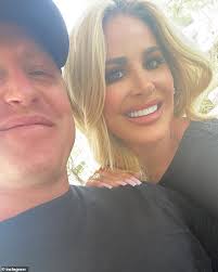 Kim Zolciak flashes her chest with reality TV producer Troy VanderHeyden