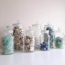 Sea glass is actually pieces of broken glass that have been polished smooth by lapping ocean waves. My Display Of Sea Glass And Beach Finds The Jars Are Art Deco Sweetie Jars I Sourced On Ebay They Sea Glass Decor Sea Glass Art Projects Sea Glass Crafts