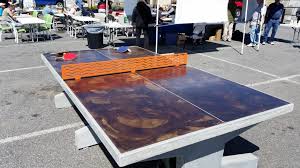 This handmade luxury ping pong table sports a sleek metallic black frame complemented by a glass top that provides a unique playing experience. Outdoor Concrete Game Table Ideas