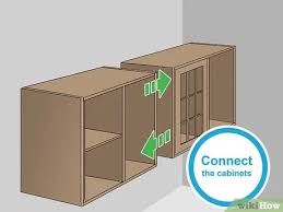 Lift the cabinets onto the ledger board and check for plumb and level. How To Hang Wall Cabinets 15 Steps With Pictures Wikihow