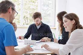 Mature guy seduces a girl. Men And Two Women Seated At Table Blueprint Mature Men Stock Photo 134273768