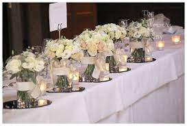Vases painted white for wedding head table for bridesmaid bouquets. Top Table Wedding Flowers Line Up Of Vases With White Flowers Bridesmaids Bouquets Reuse On Top Wedding Top Table Wedding Top Table Flowers Top Table Flowers
