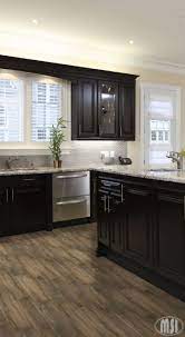 This stunning and modern kitchen uses dark cabinets to maintain a sleek and funky style, but also to limit the 'industrial' feel brought by the stainless steel worktops, appliances, and high stools. Moon White Granite Slab Home Kitchens Kitchen Remodel Idea Kitchen Design