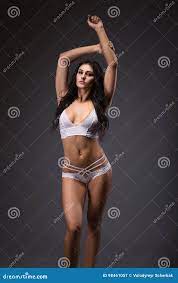 Attractive Young Girl in White Lingerie with Nice Body Raised Hands Up and  Looking Directly Stock Image - Image of camera, elegant: 98461057