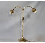 A French brass and glass two branched table lamp, 1910 to 1925.
