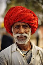 Man in red turban with white mustache