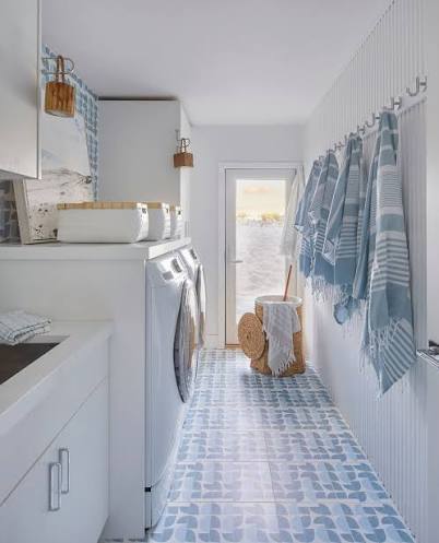 This cabana inspired sand room is designed for life at the beach.⁠ ⁠ Just  steps from the sand, this laundry and mudroom keeps towels, beach gear, and  laundry all in one thoughtfully