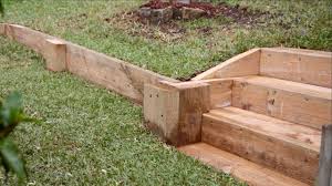 Install a straight, continuous row of foundation timbers in this manner. Easy Diy Retaining Wall Youtube