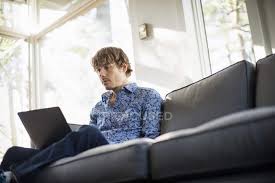 For a video game, last man sitting sounds really boring. Low Angle View Of Man Sitting On Sofa And Looking At Laptop Three Quarter Length Using Laptop Stock Photo 192691534