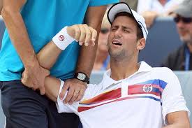 Novak djokovic is unsure if he can play in the last 16 of the australian open after he sustained an injury in world number one djokovic was hampered by a side injury that restricted his movement. Djokovic Grimaces While Receiving Treatment Abc News Australian Broadcasting Corporation