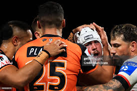 Heath Mason of the Wests Tigers celebrates a try with team mates... News  Photo