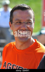 Colorado mens basketball head coach Tad Boyle, left, jokes with athletic  director Rick George after Boyle received an award in the second half of an  NCAA college football game Saturday, Oct. 2,