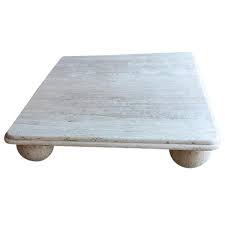 Tabletop is a square with 4 large square legs that are manufactured with a nice brass separation detail, classing it up a bit more. 1950s Italian Travertine Maximalist Square Low Stone Coffee Table With Round Ball Feet And Carved E Stone Coffee Table Travertine Coffee Table Travertine Stone