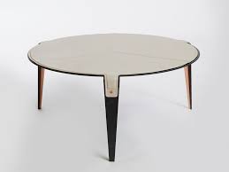 Upgrade the outdated furniture of your living room with this coveted coffee table. Gabriel Scott Bardot Round Leather Coffee Table For Living Room