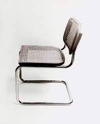 White kitchen and a dining room. These Are The 12 Most Iconic Chairs Of All Time Gq
