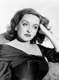 Bette Davis in the famous Margo Channing gown designed by Edith Head. I saw  this costume in an exhibit a while back and was stunned to see that it is  actually brown,