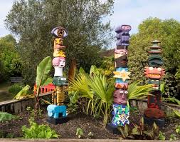 The transforming masks, button blankets, and totem poles are absolutely incredible! Dishfunctional Designs The Upcycled Garden Garden Totems