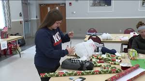 santa for seniors students wrap gifts