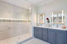 Traditional style bathroom with cherry shaker vanity with double undermount sinks, marble counters, three wall aclove tub, porcelain tile, glass walk in shower, and tile floors. Hingham Shipyard Transitional Bathroom Boston By Trudesign Co Inc Houzz