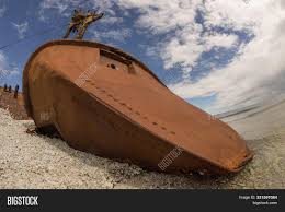Two ships from sweden and estonia on thursday left port to begin preliminary surveys for a new examination of the wreck of ferry ms estonia which sank in the baltic sea in 1994. Old Rusty Wreck Rocky Image Photo Free Trial Bigstock