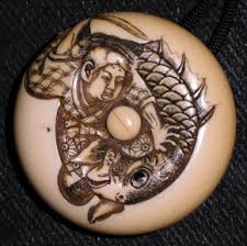 Wood, resin bone and a toggle. International Netsuke Society Faq