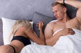 Worried Naked Man Laying In Bed With Sexy Woman In Lingerie Stock Photo,  Picture And Royalty Free Image. Image 76738046.