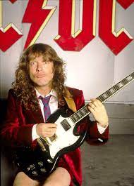 With the guy with the long blonde hair wiggling his hips. Image Of Angus Young
