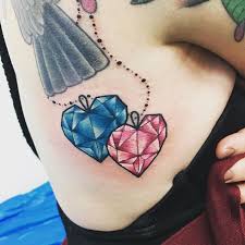 The most common rib cage tattoo material is metal. Pink And Blue Heart Shaped Diamond Tattoo On Side Rib Cage