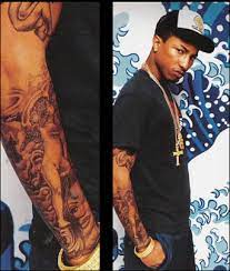 Hear pharrell geek out about his tattoos. Pharell Celebrity Tattoos Tattoo Removal Pharrell Williams
