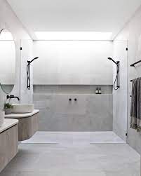 Grey Bathroom With Skylight Double Shower Curved Cabinetry And Shower Niche Bathroom Interior Design Bathroom Design Luxury Bathroom Interior