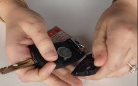 First, flip the key fob over, then push the the small release latch. How To Change A Key Fob Battery With A Key Lawrence Kia