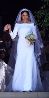 The 9news live blog meghan's dress is a bespoke lily white high neck gown made of silk crepe, which showed her bare shoulders. Who Designed Meghan Markle S Wedding Dress