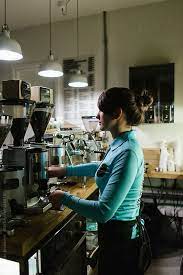 female barista working at the coffee shop by brkati krokodil cafe barista coffee shop photography coffee shop restaurant photography