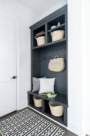 These 25 chic mudroom ideas fit the bill. A Gorgeous Black And White Graphic Rug Sits On A Wood Floor In Front Of A Built In Black Mudroom Bench Boasting Cubbies Mudroom Design House Design White Doors