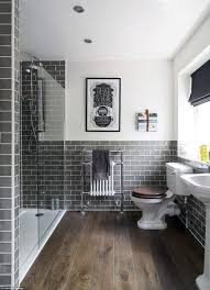 Slate blue powder room walls complement a marble and brass washstand fixed against an oak herringbone pattern floor and beneath a capiz mirror lit by brass sconces with white shades. Top 60 Best Grey Bathroom Tile Ideas Neutral Interior Designs