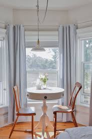 Small Vintage White Table In Bay Window With Farmhouse Chairs Victorian Living Room Farmhouse Chairs Two Bedroom Suites