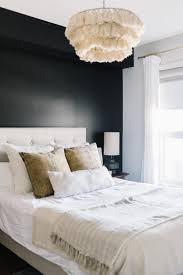 Black happens to work beautifully with brass accents, warm wood tones and crisp white. Modern Bedroom With Black Wall Black Walls Bedroom Feature Wall Bedroom Bedroom Wall Colors