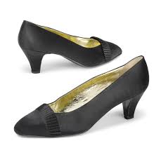 Oltre '50 anni di esperienza nel settore della calzatura. A Pair Of Black Satin Court Shoes